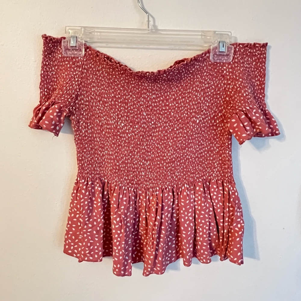 Pink with polka dots, flexible, off the shoulder shirt.